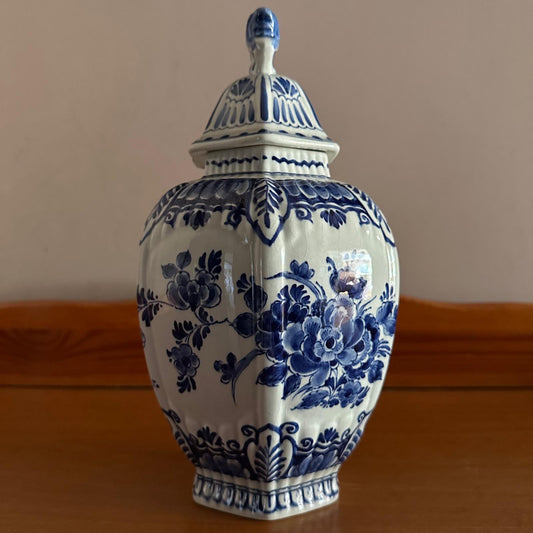 Ceramic jar with blue floral patterns on a wooden surface