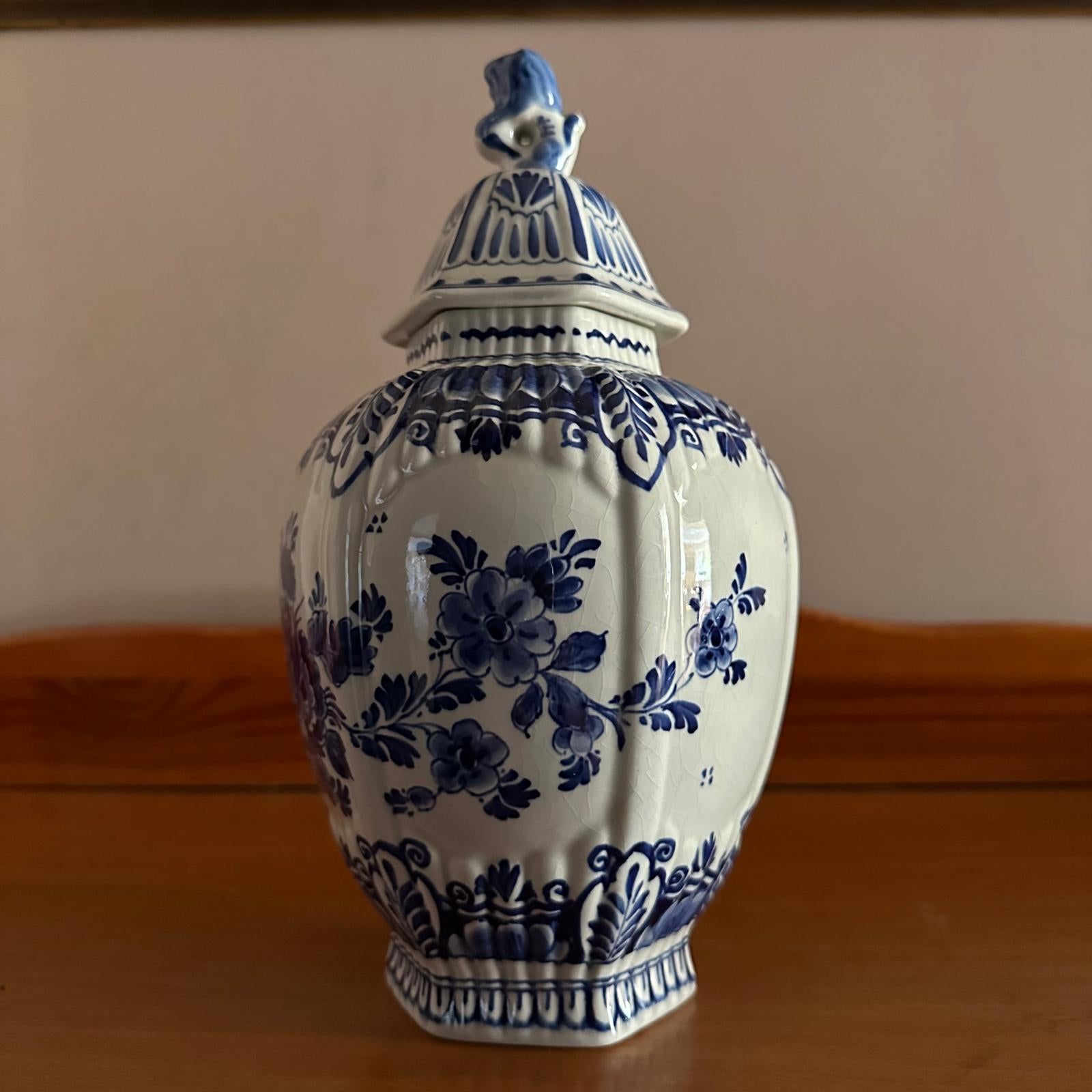 Blue and white ceramic jar with floral patterns on a wooden surface