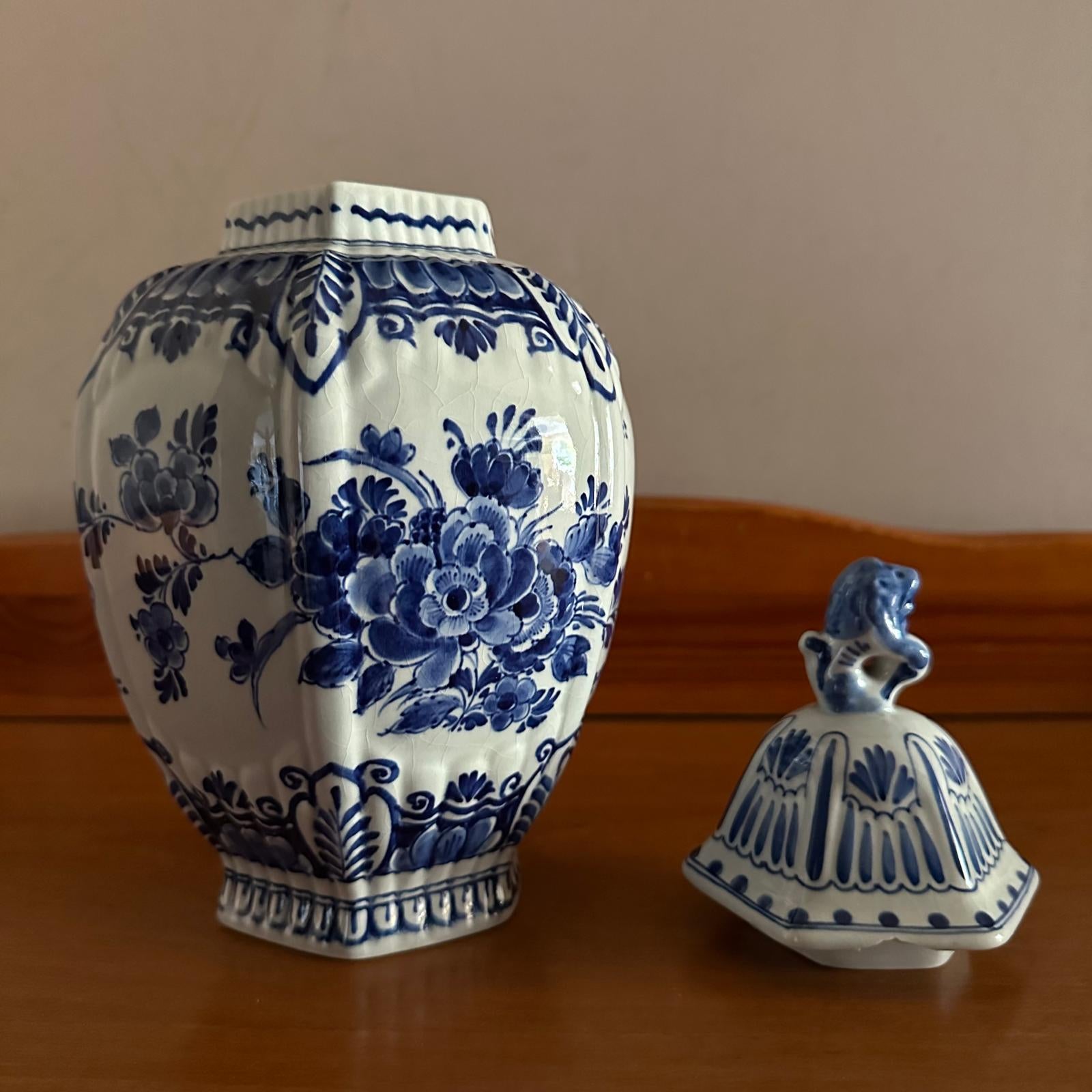 Ceramic jar with blue floral patterns on a wooden surface