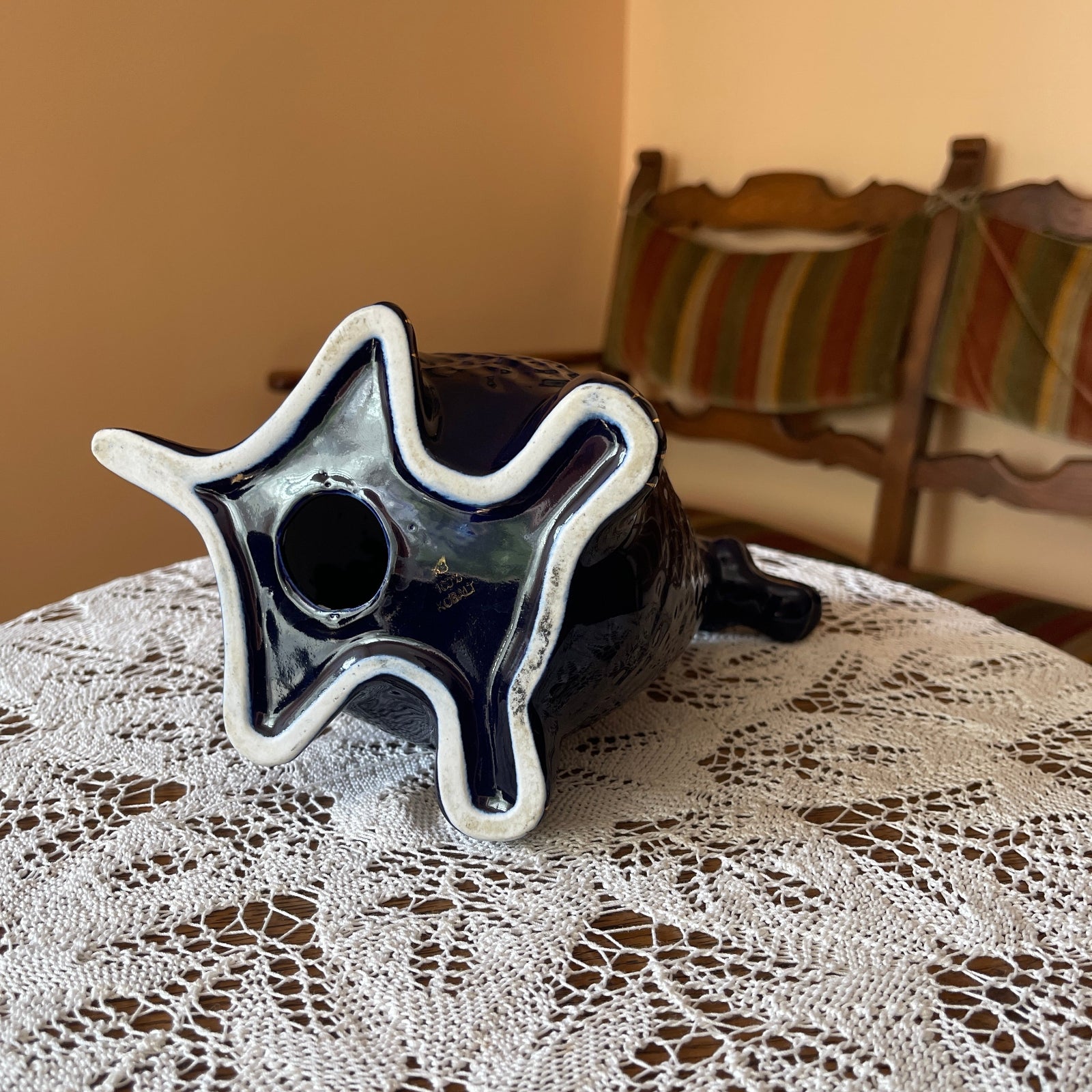 Star-shaped ceramic object on a lace tablecloth with a blurred background