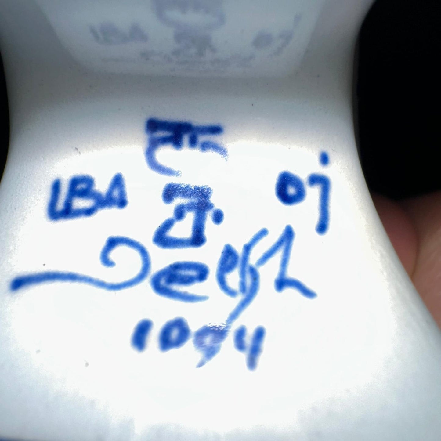 Close-up of a white container with blue text and numbers on a white background